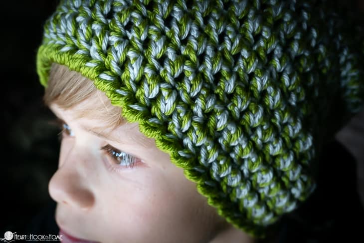 Green and white example of the Easy Peasy 30-Minute Beanie Crochet Pattern being modeled by a male child.