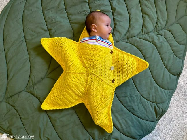 baby in yellow star sleeper crocheted