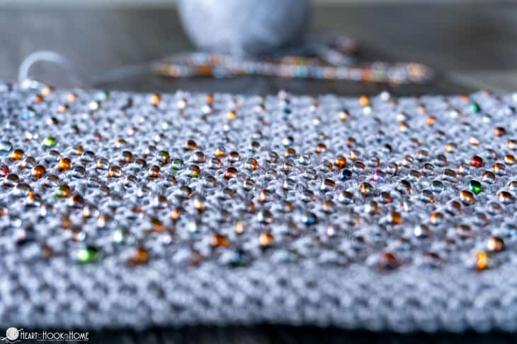 Gray sample of the Cross-Body Bead Bag crochet pattern with natural colored beads.