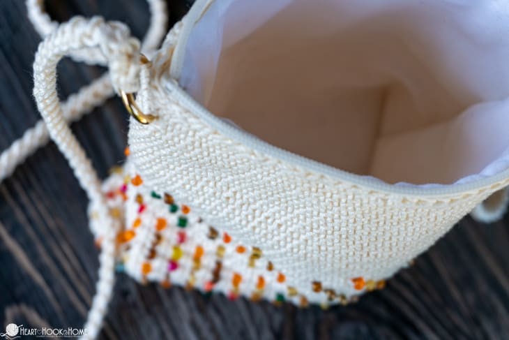 White example of the Cross-Body Bead Bag crochet pattern with \"Magic Copper\" colored beads.