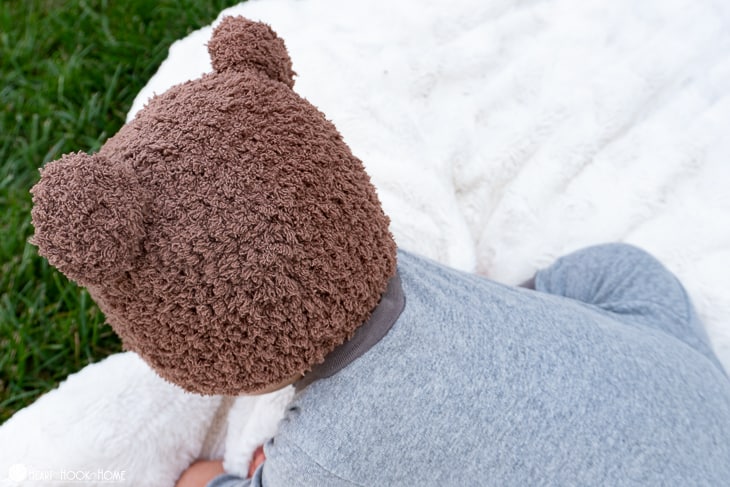 Chocolate brown example of the Bear-ly Scary Beanie crochet pattern on a small child.