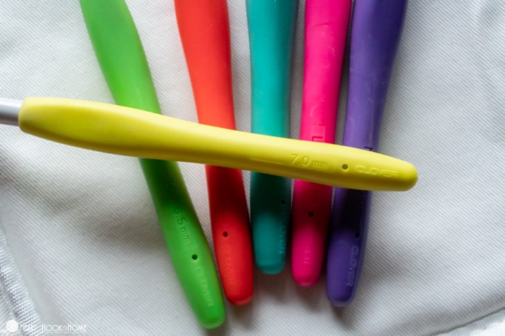 Clover Amour crochet hooks in yellow, green, red, blue, pink, and purple.