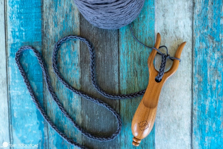 Brown Lucet Fork with an in progress drawstring.