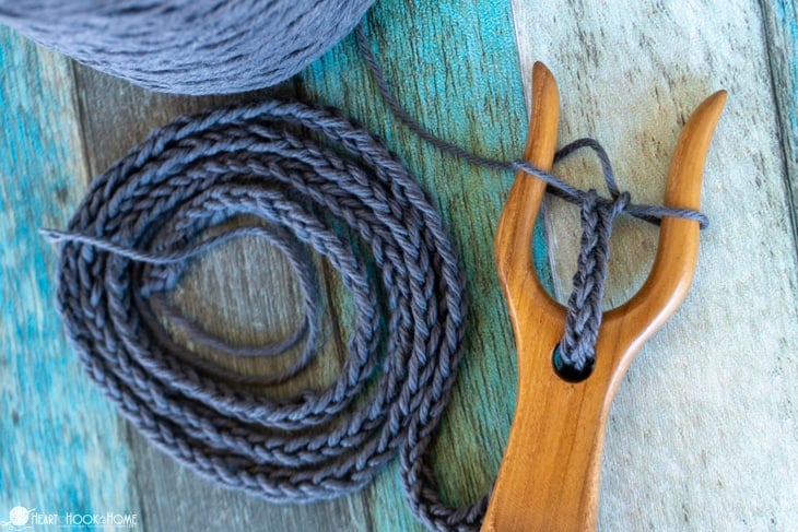 Brown Lucet Fork with an in progress drawstring.