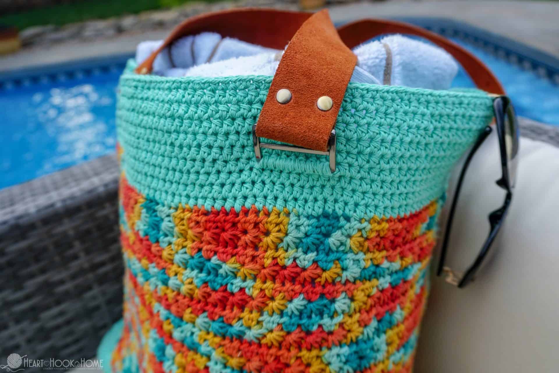 Teal, red, and orange example of a Life's a Beach Bag crochet pattern with leather straps.