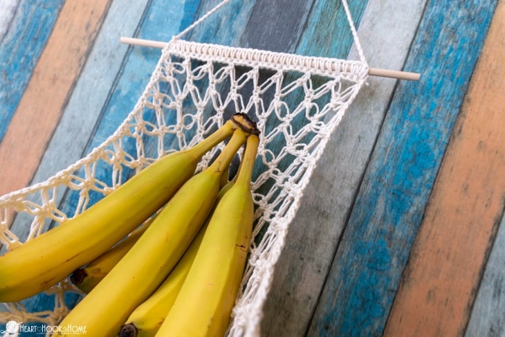 Example of a Fruit Hammock crochet pattern in a white colorway with 5 bananas lounging on it.