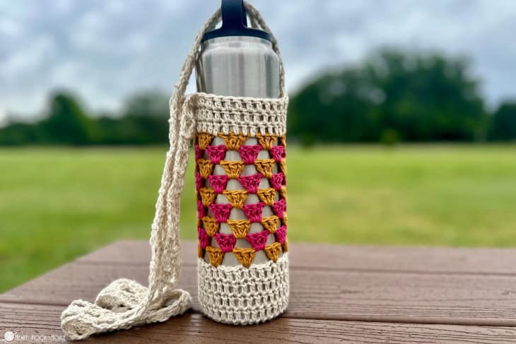 granny stitch crochet water bottle carrier at the park
