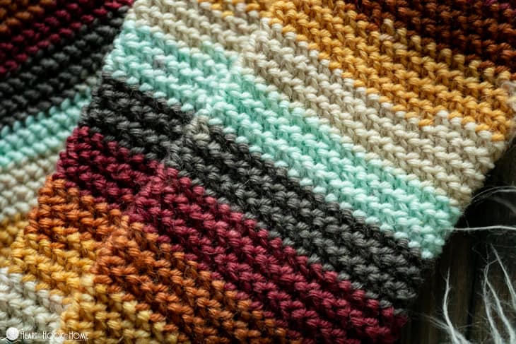 An example of the Herringbone Socks crochet pattern in striped fall colors.