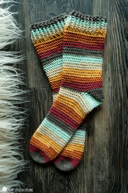 An example of the Herringbone Socks crochet pattern in striped fall colors.