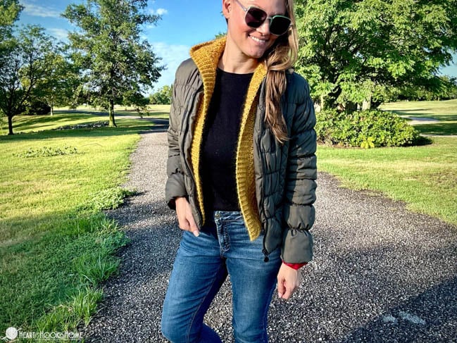 gold crocheted hooded vest with green puffer jacket