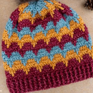 Light blue, yellow, and red colorway example of an Aspen Dreams Beanie crochet pattern.