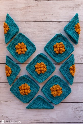 Multiple examples of the Marigold Sky Granny Square crochet pattern laid out in the shape of the Marigold Sling Bag crochet pattern.