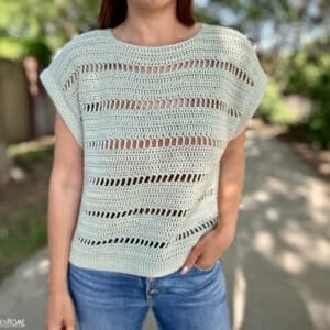 Godiva Tee on a female model wearing jeans in a park.