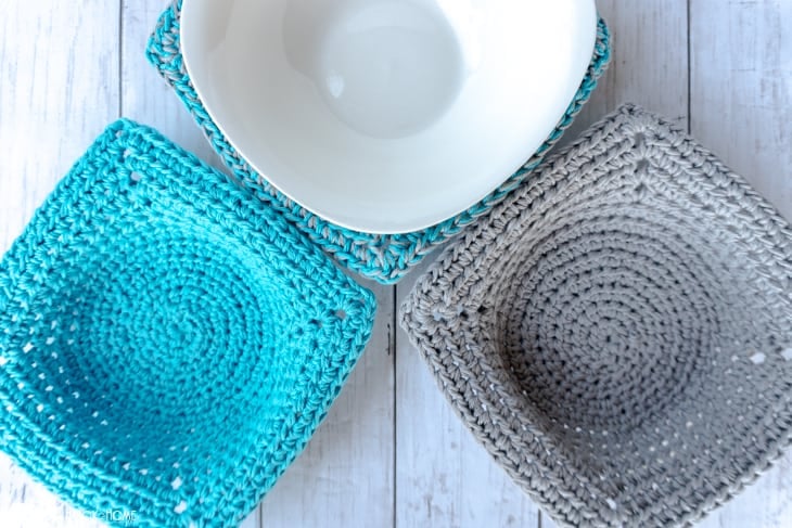 Three examples of the Quick & Easy Microwave Bowl Cozy Crochet Pattern in Teal and Gray colorways with a white bowl nestled in one of them.