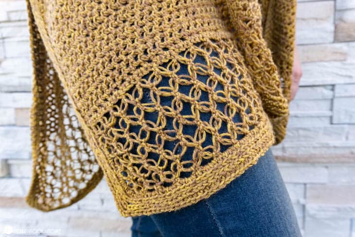 Bottom portion of a golden example of the Come On I Wanna Ruana crochet pattern.