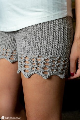 Up close of a silver colorway of the Staycation Shorts crochet pattern on a female model.