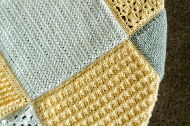 Silver, white, and gold example of the Crochet Stitch Sampler Afghan Pattern.